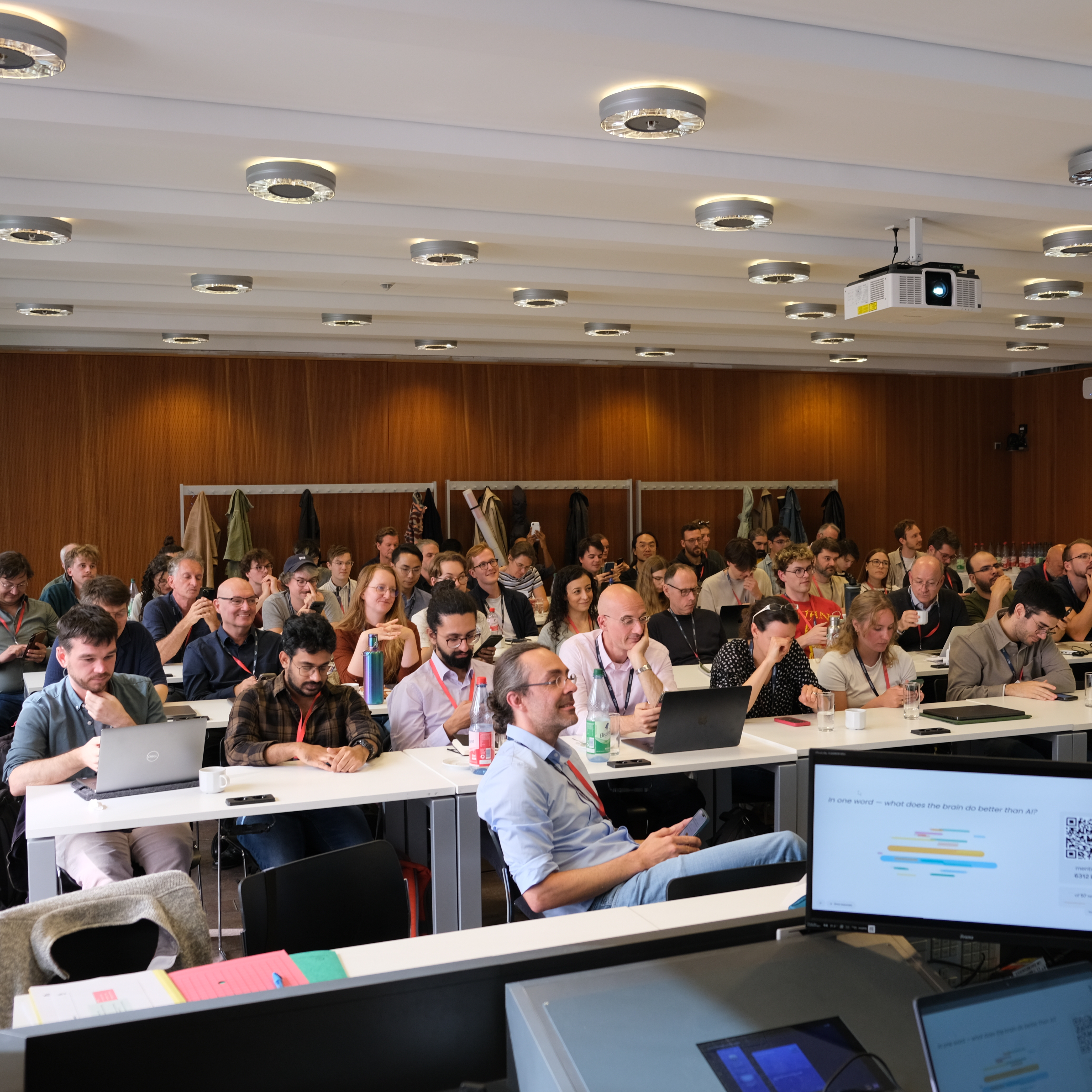 Audience in the lecture hall responding to a live poll